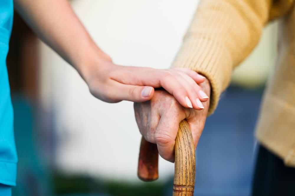 Doctor holding an old woman's hand