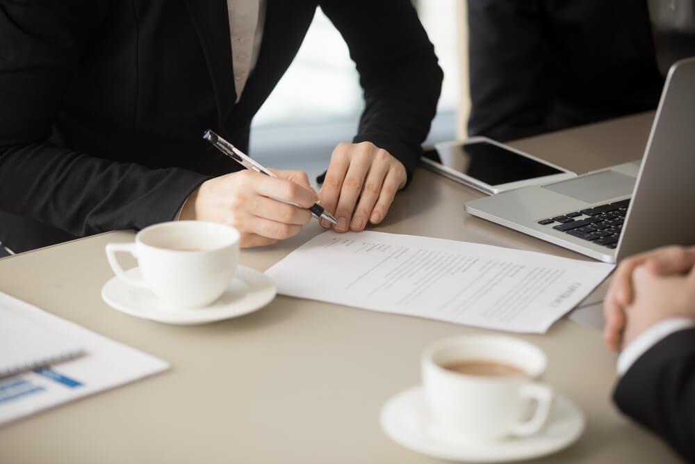 Businesswoman signing a personal guarantee